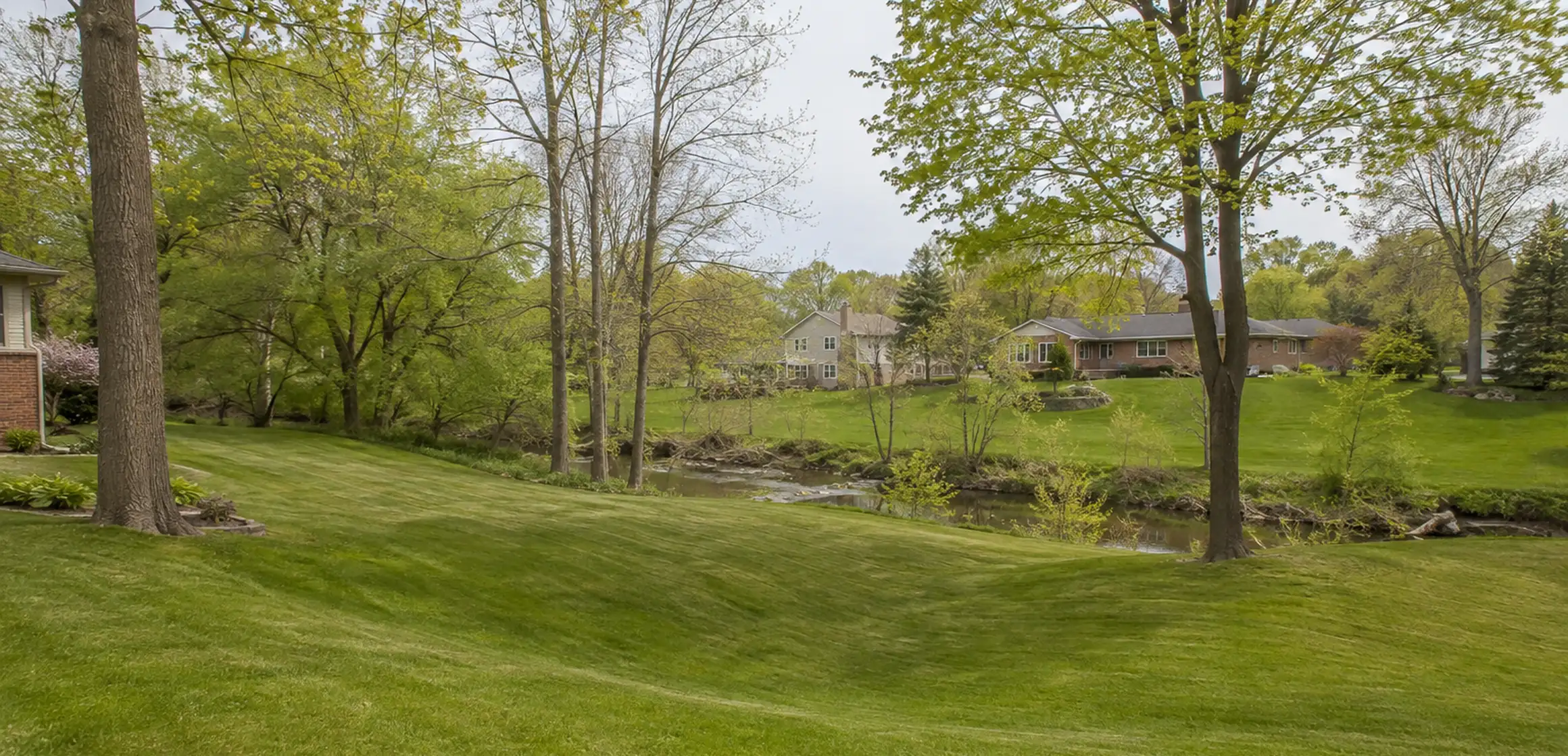 Raised ranch home with a well-kept lawn and concrete driveway